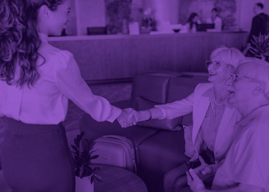 Hotel staff warmly greeting guests in a lobby lounge
