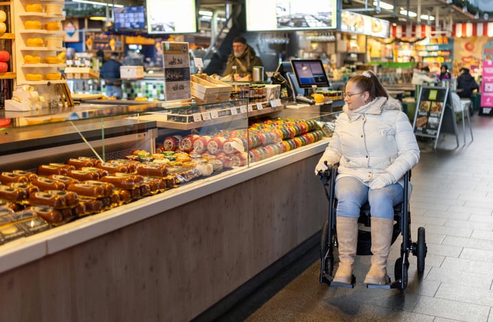 Wheelchair user at market stall